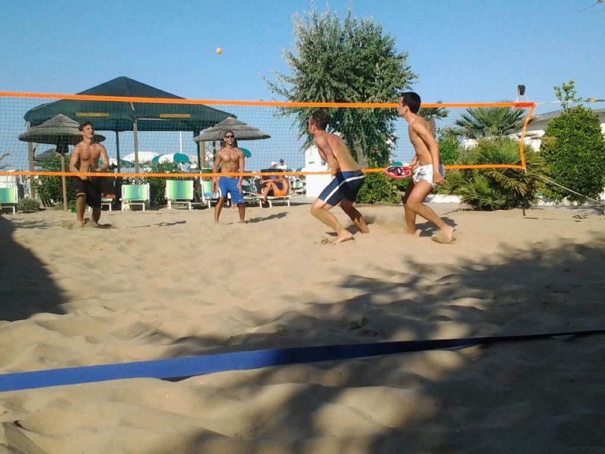 Beach racket game with friends on the sand in Rimini