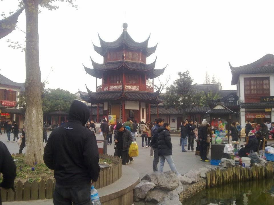 Old-town square in Shanghai, a pagoda rising over the crowd