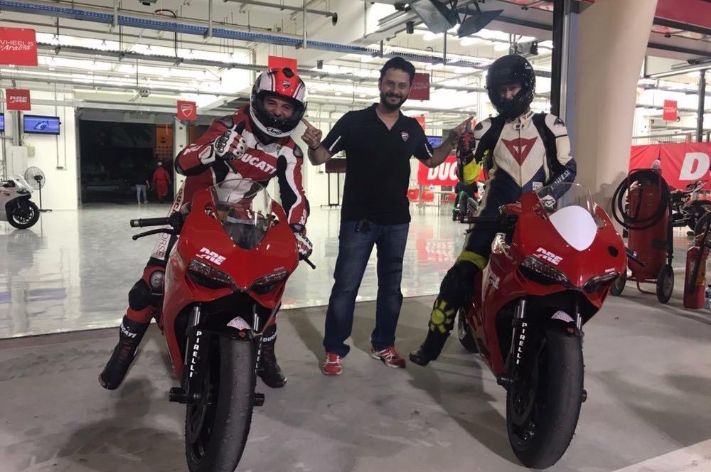 Riding Experience pit garage, two riders on superbikes ready to go out